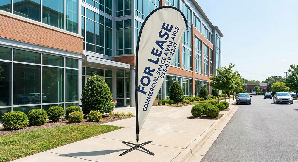 Custom 11.5ft tear drop flag labeling the building 