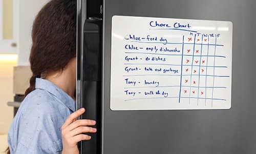 Dry erase magnet chore chart on door of a fridge