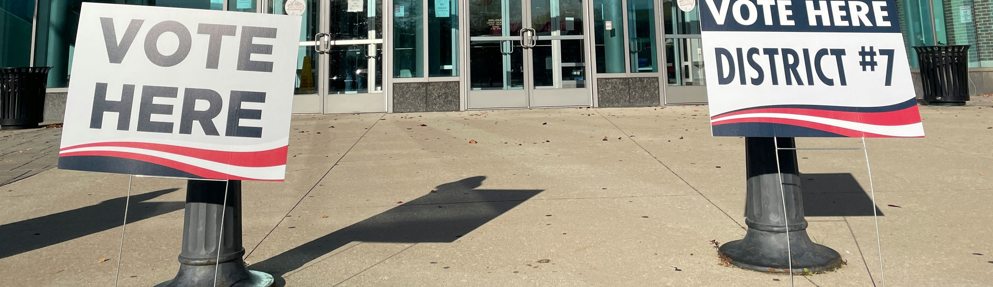 Political yard signs displayed in front of voting facility