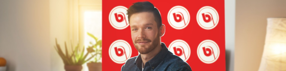 Man standing in front of logo step and repeat banner